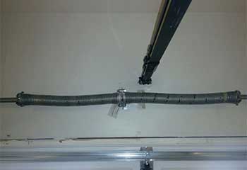 Broken garage door torsion spring awaiting replacement in Mission Viejo CA home