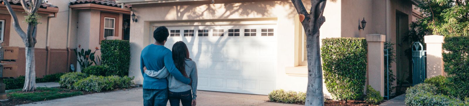 Couple standing in front of their Aliso Viejo home with new garage door