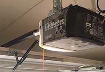 Technician adjusting LiftMaster 1/2 HP garage door opener unit during repair at Aliso Viejo CA home
